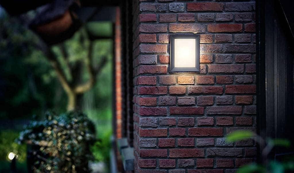 The Philips Karp LED outdoor wall light in anthracite grey suspends a large panel of diffuse warm white light in an elegant frame of