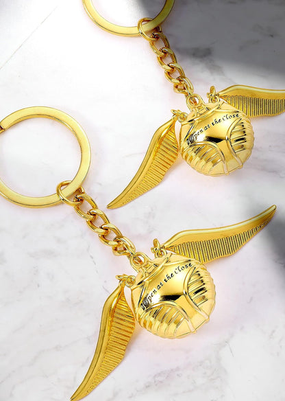 Harry Potter Golden Snitch porte-clés, The Carat Shop Llavero 3D oficial de Harry Potter Golden Snitch, Oro, Medium, The Carat Shop: Harry Potter Golden Snitch Schlüsselanhänger 3D - Harry Potter Gadget, Metall, Kein Edelstein., Harry Potter Official Gold