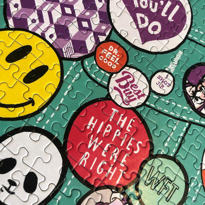 Pinned / 1,000 piece adult Jigsaw Puzzle for Adults from Happily featuring an illustration of pins & badges