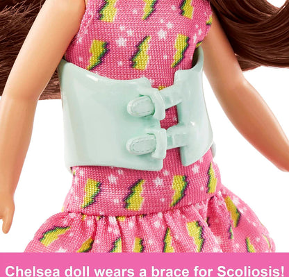 Barbie Toys, Chelsea Doll, 6-Inch Small Doll with Brace for Scoliosis Spine Curvature, Brunette Wearing Pink Lightning Bolt Dress