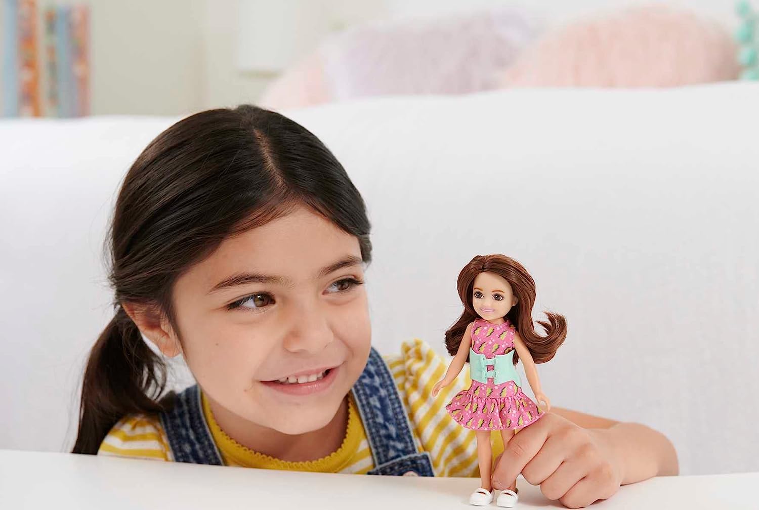 Barbie Toys, Chelsea Doll, 6-Inch Small Doll with Brace for Scoliosis Spine Curvature, Brunette Wearing Pink Lightning Bolt Dress