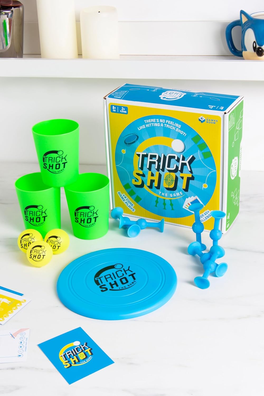 Fizz Creations Trick Shot The Game. Includes All You Need to Practice the Perfect Shot! Includes Stacking Cups, Ping Pong Balls, Sticky Darts, Throwing Disc & Challenge Cards.