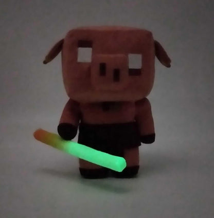 Mattel MINECRAFT Legends - Piglin Fluo, 14+ cm Tall Plush Toy with Sounds and Glow in the Dark Sabre, Soft Video Game Character, Toy for Children, 3+ Years, HHC88
