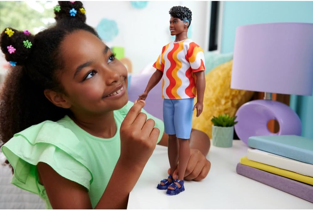 Barbie Fashionistas Ken Doll #220 with Behind-the-Ear Hearing Aids & Broad Body Wearing a Removable Orange Patterned Shirt, Shorts & Jelly Sandals, HRH23