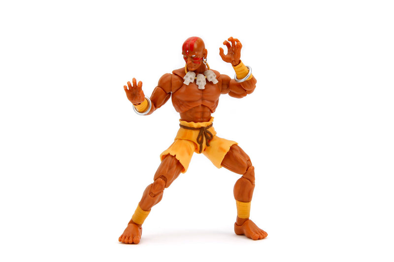 Jada - Street Fighter 2- Figura articulada de Dhalsim de 15 cm. con Manos y Cabeza Intercambiables, Accesorios y 20 Puntos articulados. A Partir de 13 años (253252031