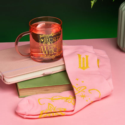 Paladone Wicked Movie Glass Mug & Socks Gift Set - Officially Licensed Disney Gift for Wicked Fans, Pink Tinted The Best Witch of All Mug & Cozy Emerald City Ankle Socks