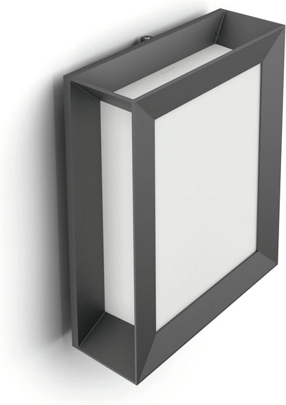The Philips Karp LED outdoor wall light in anthracite grey suspends a large panel of diffuse warm white light in an elegant frame of