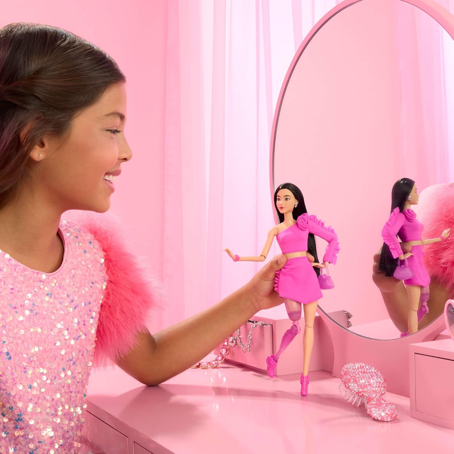 Barbie Deluxe Style Doll #2 in Barbiecore Outfit, Black Hair and Glittery Prosthetic Leg, Pink Top and Skirt Set with Rosette Detail and Accessories