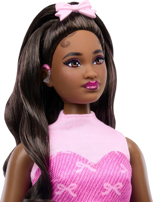 Barbie Deluxe Style Doll #10 in Pink Denim Top and Skirt Set with Bow Print, Black Hair, Behind-the-Ear Hearing Aids and Accessories like Handbag, JJN70