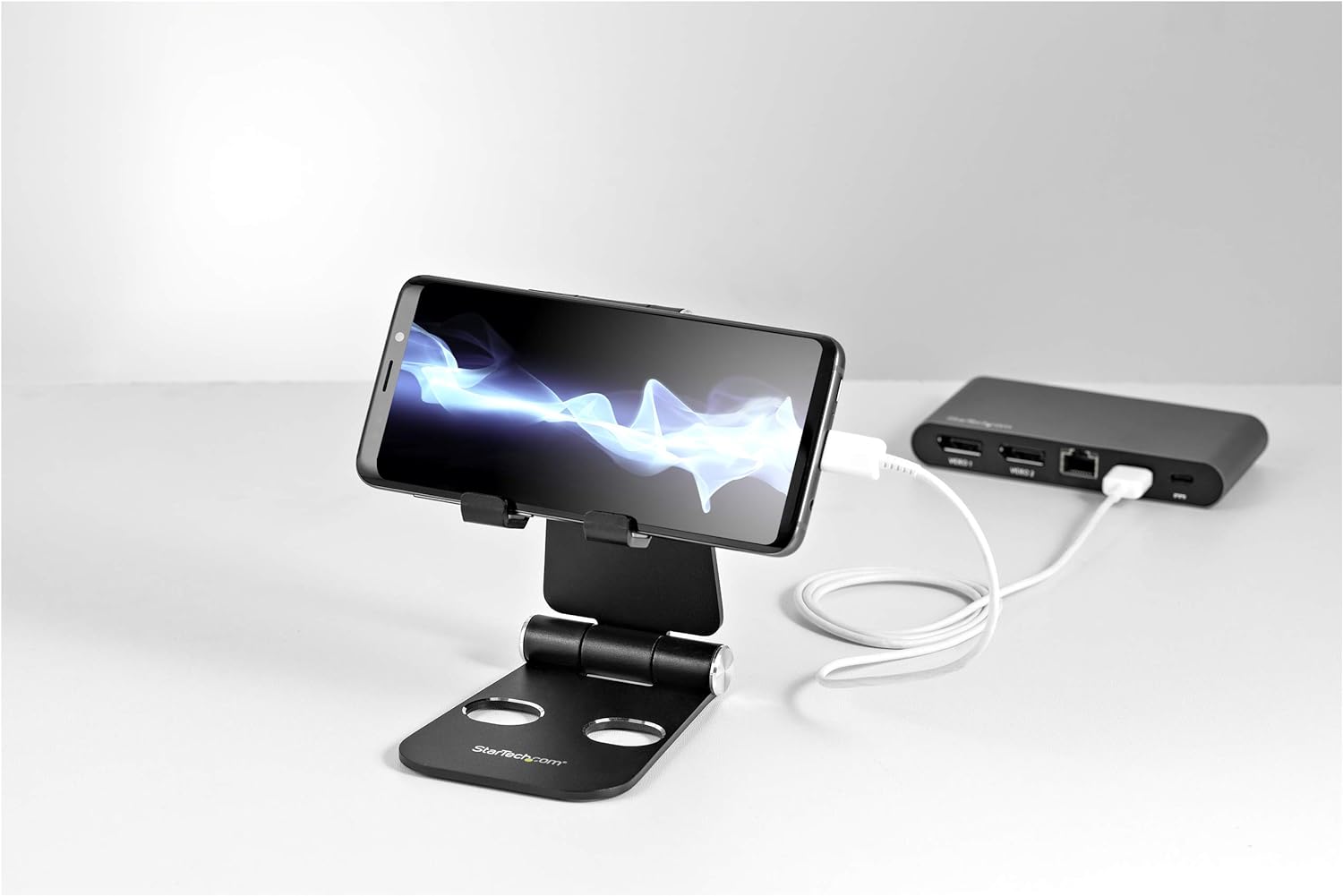 StarTech.com Phone and Tablet Stand - Foldable Universal Mobile Device Holder for Smartphones & Tablets - Adjustable Multi-Angle Ergonomic Cell Phone Stand for Desk - Portable - Black (USPTLSTNDB